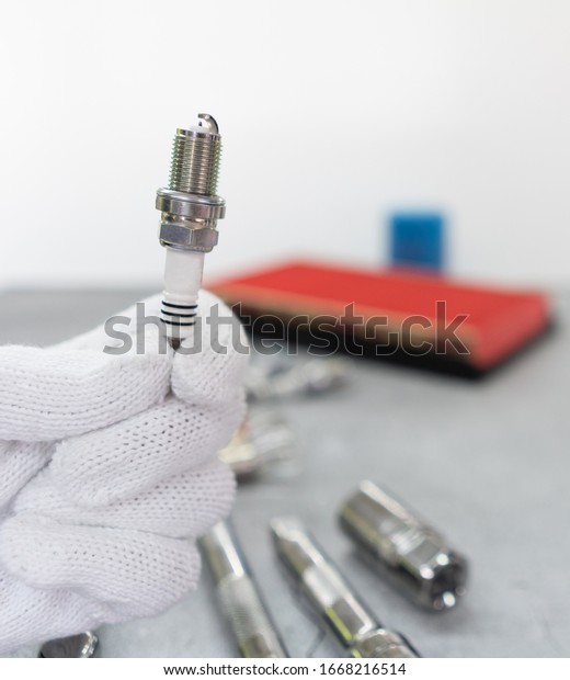 Mechanic hold new iridium spark plug with\
small electrode core for high precision ignition in difficult\
condition at high boost or lean mixture. Conceptual for automotive\
part or service\
advertisement