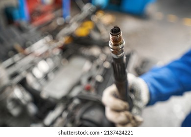 Mechanic Holding Car Part In His Hands