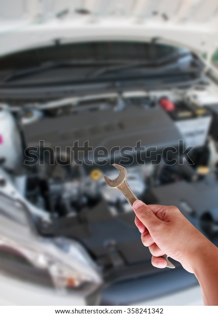 Mechanic Holding
Spanner Fixing Car
Engine