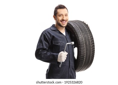 Mechanic Holding A Tire And A Lug Wrench Isolated On White Background