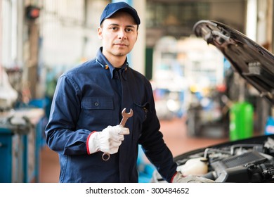 Mechanic Holding A Wrench In His Garage