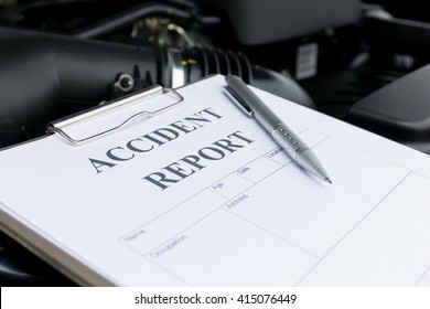 Mechanic Inspecting Damage Car And Filling In Accident Report Form 