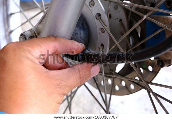 Mechanic\
inspecting the motorcycle mileage\
line