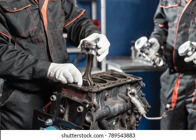 the mechanic installs a new piston. Disassemble engine block vehicle. Motor capital repair. Sixteen valves and four cylinder. Car service concept. - Powered by Shutterstock