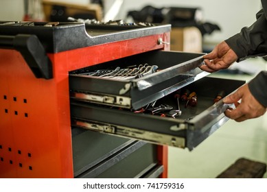 Mechanic looking for some tools for work at an auto shop. - Powered by Shutterstock