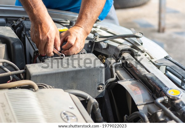Mechanic\
maintenance car battery. Car service\
concept.