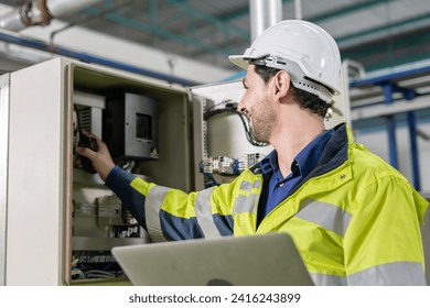 Mechanic or maintenance or electrical engineer checking main electrical control systems industrial plant. Utility fore man daily check power systems in process. Main Distribution Board, Switchboards