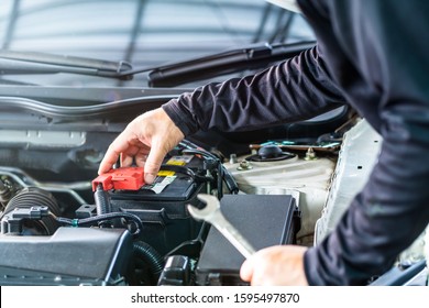 Mechanic man check battery pole cover, inspection and maintenance car service
