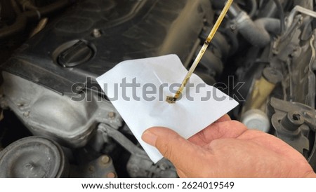 Mechanic man checking engine oil refill car maintenance close up engine.Car lubricator check