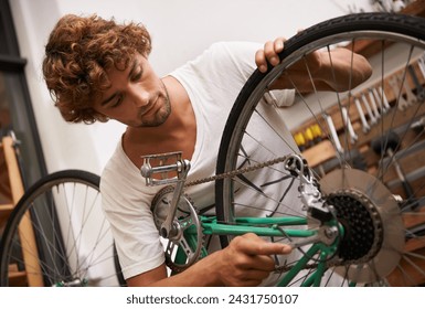 Mechanic, man and fixing bicycle with tools at workshop for repair, maintenance with small business. Entrepreneur, handyman and garage as expert for bike with equipment for service and upgrade - Powered by Shutterstock