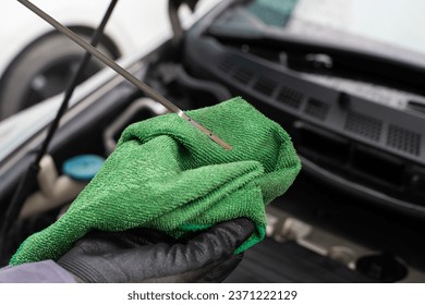 Mechanic man hand checking engine oil refill car maintenance close up engine transport industry