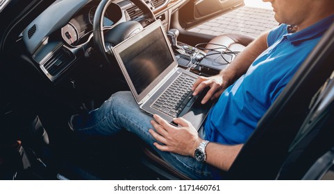 Mechanic Man With Laptop Making Car Diagnostics At Auto Service. Background