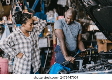 Mechanic man talking with stress worry customer inform explain car problem, service detail hard decision in garage. - Powered by Shutterstock