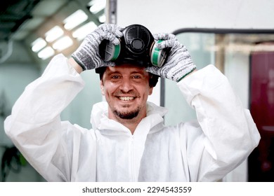 Mechanic man in white costume cloth wearing chemical protective mask before working with painting tool, auto mechanic fixing repairing vehicle at garage, technician maintenance customer car automobile - Powered by Shutterstock