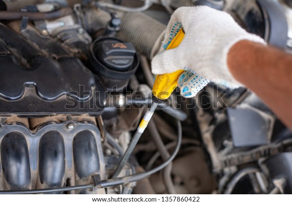 mechanic men with
wrench repairing car engine at workshop - auto service, repair,
maintenance and people
concept.
