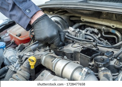 mechanic is opening the oil cap for change of oil from a car engine. auto service