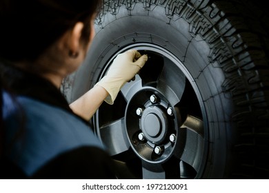 Mechanic Opening Valve Stem On A Tire