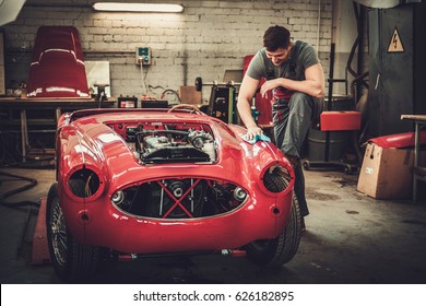 Mechanic Polishning Car In Restoration Workshop