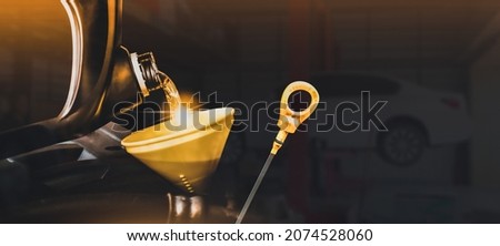 Mechanic pouring motor oil to engine with copy space on black background,Double exposure,Automobile repair shop business concept Foto stock © 
