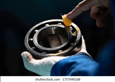 Mechanic Is Putting Yellow Grease In The Into Bearing, Engineering And Industrial Concept