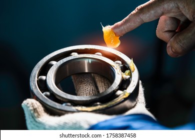 Mechanic Is Putting Yellow Grease In The Into Bearing, Engineering And Industrial Concept