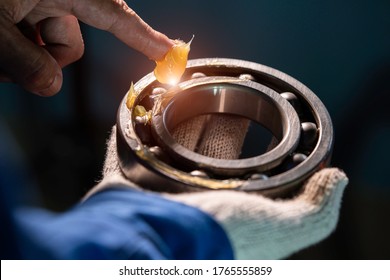 Mechanic Is Putting Yellow Grease In The Into Bearing, Engineering And Industrial Concept
