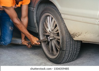 The mechanic is removing the wheels to fix the shock. - Powered by Shutterstock