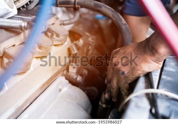 Mechanic repair Car fixing motor in garage wrench\
vehicle parts automobile service. Technician using tools equipment\
check maintenance in auto\
center