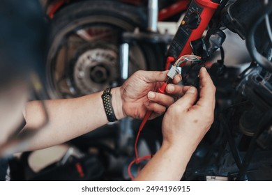 Mechanic repair or wiring motorcycle in garage. Repair or maintenance concept. - Powered by Shutterstock