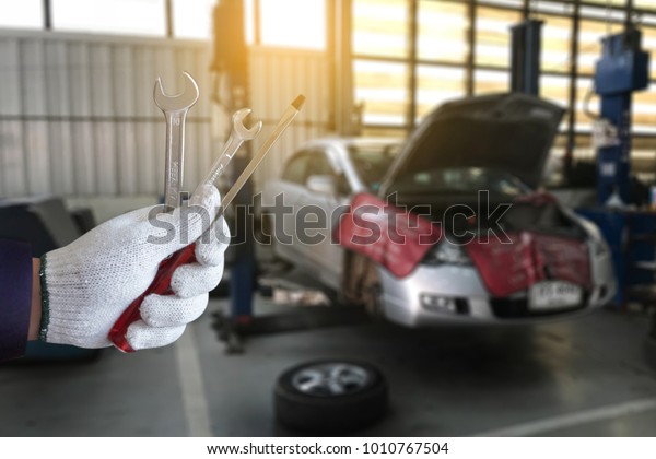 Mechanic repairing a car  in garage  Auto repair
car engine