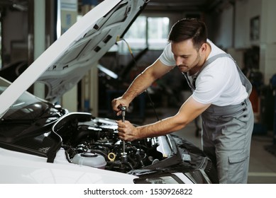 Mechanic is repairing an engine in the auto repair shop