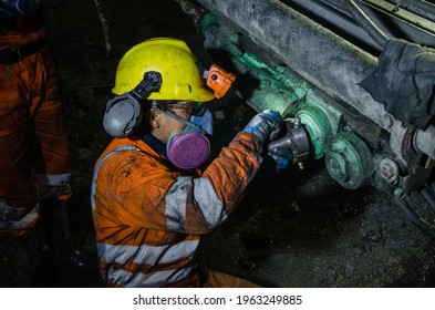 Mechanic repairing a mining machine