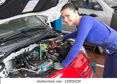 Mechanic Repairing The Motor Or Electric Parts Of A Car In A Garage