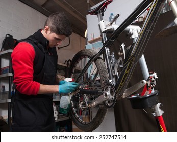 Mechanic Repairing A Mountain Bike In A Workshop