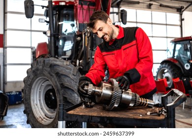 Mechanic repairing and servicing transmission for tractor agricultural machine. - Powered by Shutterstock