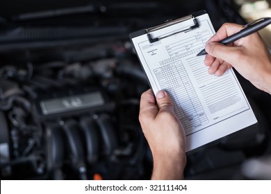 mechanic repairman inspecting car closeup - Powered by Shutterstock