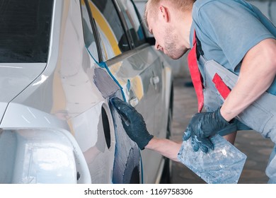 Mechanic repairs the car body after a car accident