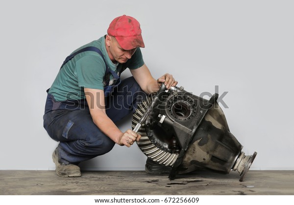 Mechanic repairs the\
truck