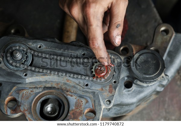 The mechanic repairs the truck. Repair and\
adjustment of brake\
caliper.