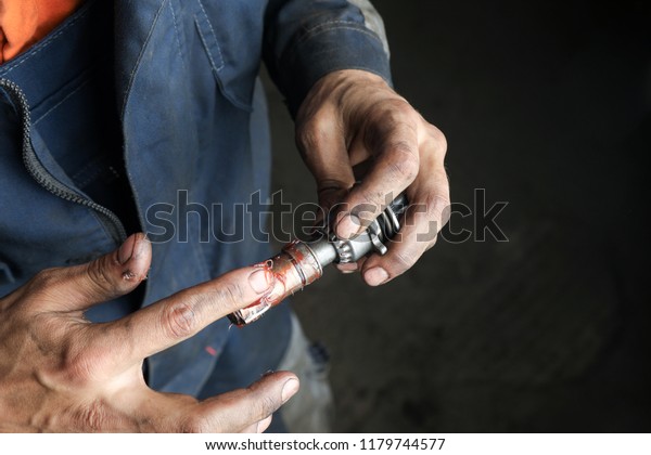 The mechanic repairs the truck. Repair and\
adjustment of brake\
caliper.
