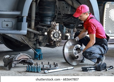 A Mechanic Repairs A Truck. Replace Brake Disc And Pads