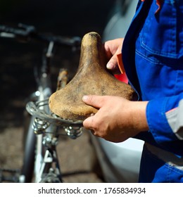 Mechanic Replacing Old Bike Seat, Outdoor Closeup