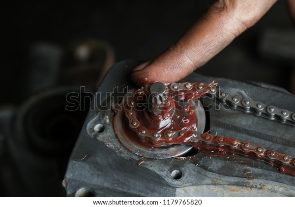 The mechanic serves\
the truck. Repair brake caliper. Close-up. Maintenance. Brake\
system. Chain mechanism of the support. Brake spare parts. Hands\
working close-up.