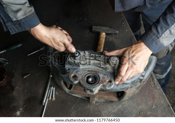 The mechanic serves the truck. Repair brake\
caliper. Close-up. Maintenance. Brake system. Brake spare parts.\
Hands working close-up.