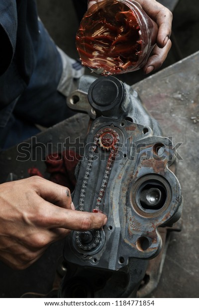 The mechanic serves the truck. Repair brake
caliper. Close-up. Maintenance. Brake system. Brake spare parts.
Hands working close-up.