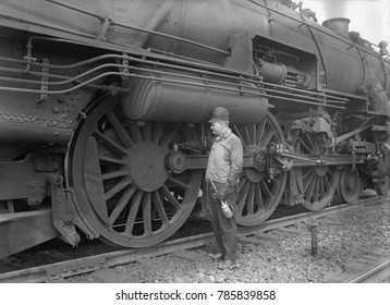 Mechanic Servicing A Railway Steam Engine In 1924. Massive Locomotives Has Increased Speed And Power To Move Heavier Loads