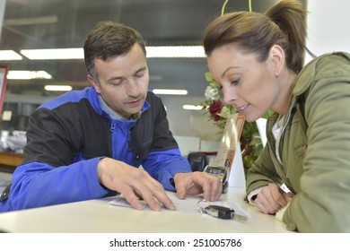 Mechanic Showing Repair Bill To Car Owner