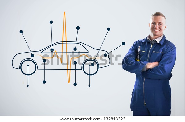 Mechanic standing in front of a background with car\
diagram on it