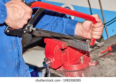 Mechanic Starting To Cut An Iron Plate By Hand With A Metal Saw, Selective Focus On The Saw Blade. Metal Carpentry Work, Unrecognisable Person.