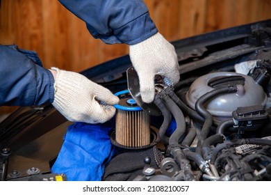 A Mechanic Takes Out An Old, Dirty Fuel Filter After Refueling With Low-quality Fuel. Car Maintenance